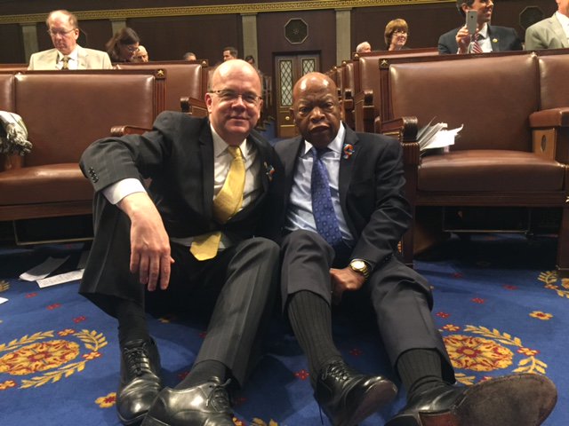 Rep. Jim McGovern and Rep. John Lewis sitting on the floor of the House of Representatives together.
